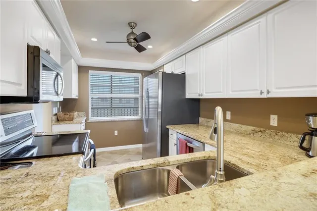a kitchen with a stove a sink and a granite counter tops