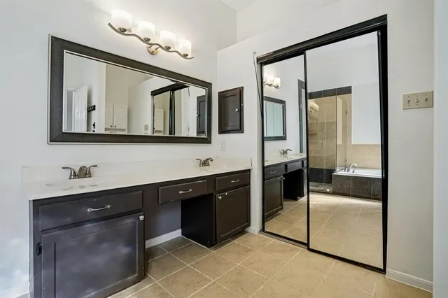 a spacious bathroom with a mirror sink and mirror