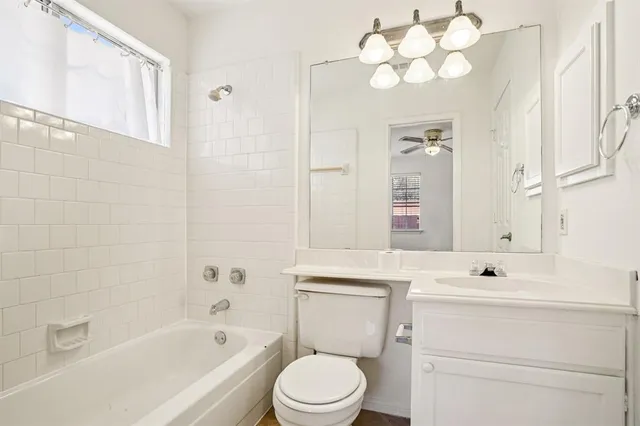 a bathroom with a sink vanity mirror and toilet