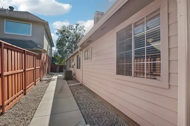 a view of a house with a wooden fence