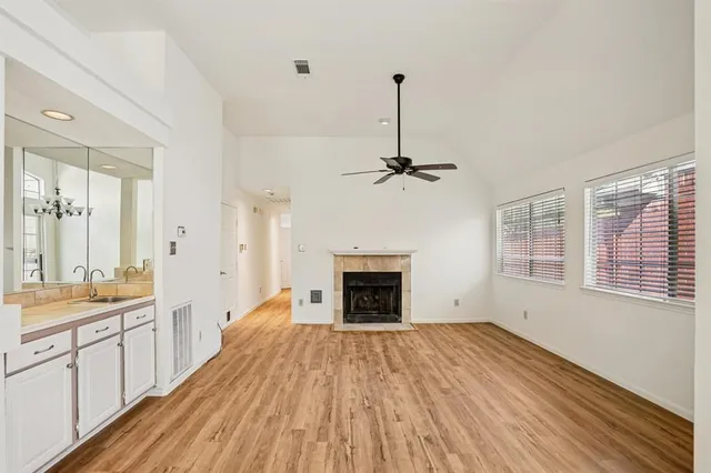 a spacious bedroom with a bed and a chandelier