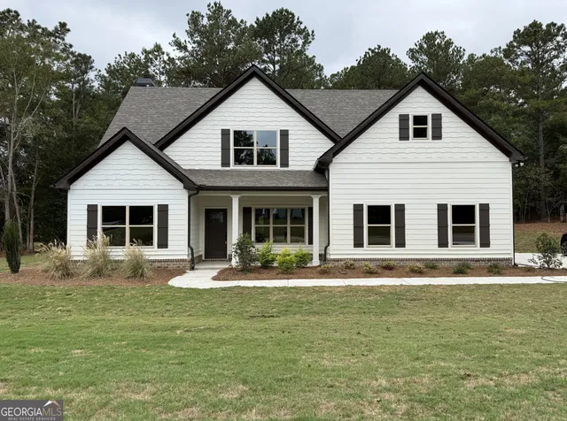 a front view of a house with swimming pool and porch