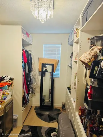 a view of walk in closet with clothes