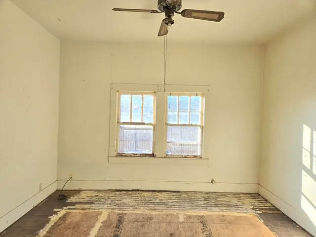 an empty room with a empty space and windows