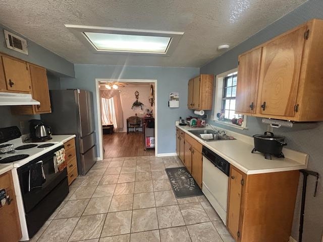 3934 Kerwin Drive Memphis, TN 38128 - Photo 4 of 15 Kitchen featuring light countertops, under cabinet range hood, a sink, range with electric stovetop, and white dishwasher