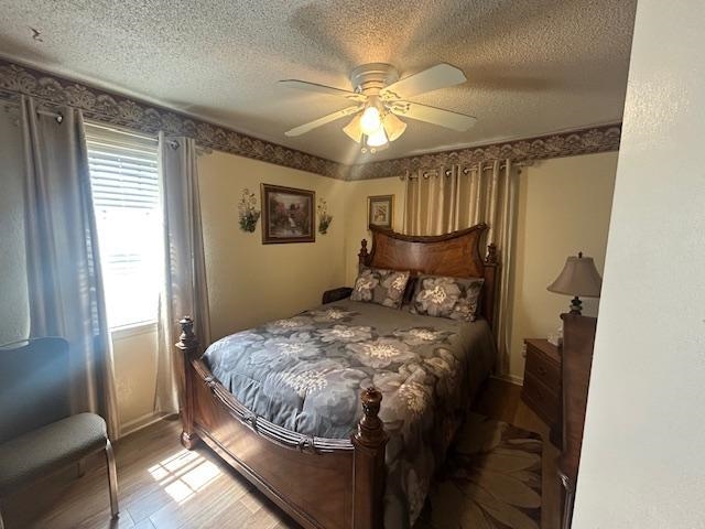 3934 Kerwin Drive Memphis, TN 38128 - Photo 7 of 15 Bedroom with a textured ceiling, light wood-style floors, and ceiling fan