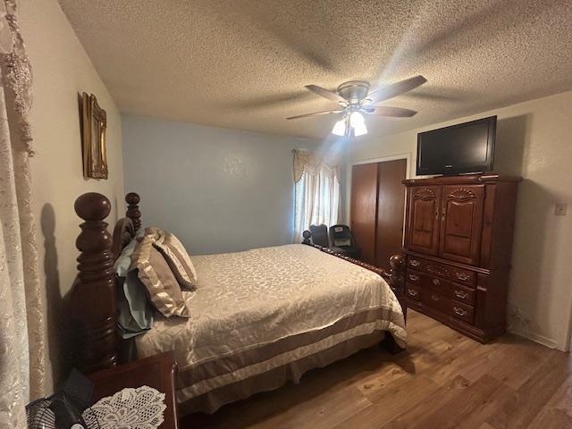 3934 Kerwin Drive Memphis, TN 38128 - Photo 9 of 15 Bedroom with a textured ceiling, light wood-style floors, and a ceiling fan