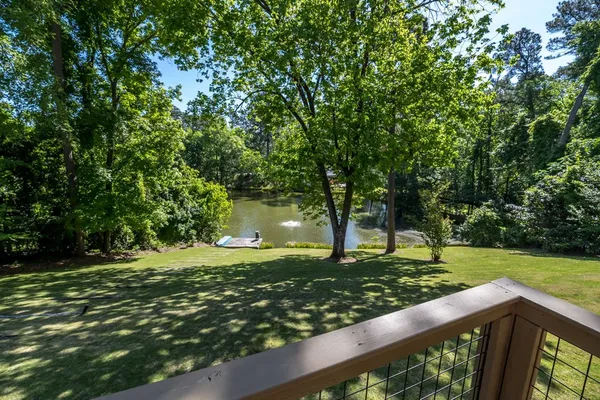 a kitchen with stainless steel appliances kitchen island granite countertop a table chairs in it and wooden floors