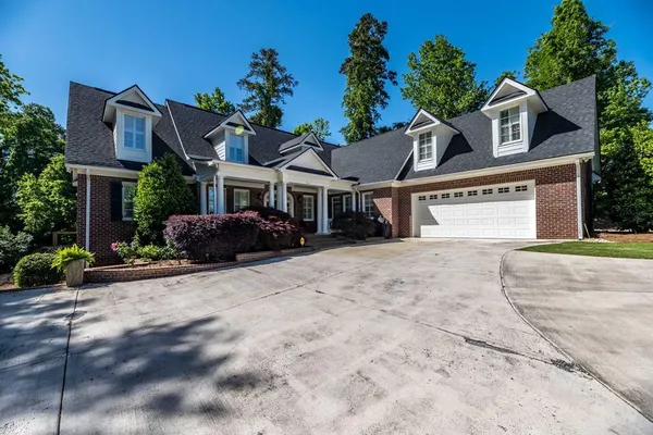 a front view of a house with a yard and a garage