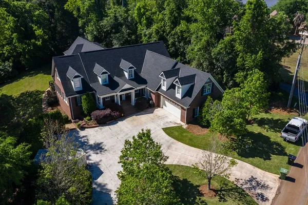 an aerial view of a house with garden space and street view