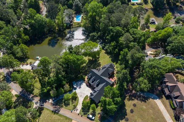an aerial view of a house with a yard and lake view