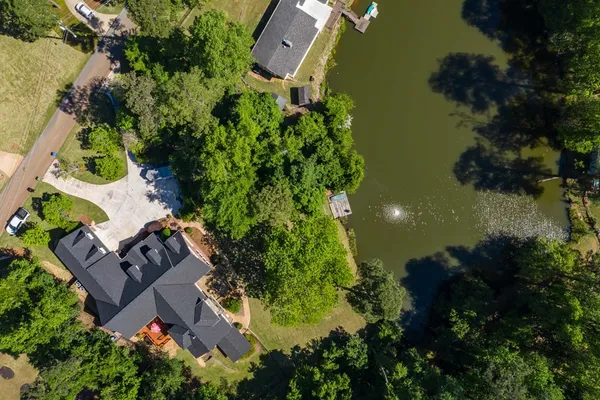 an aerial view of house with yard swimming pool and outdoor seating