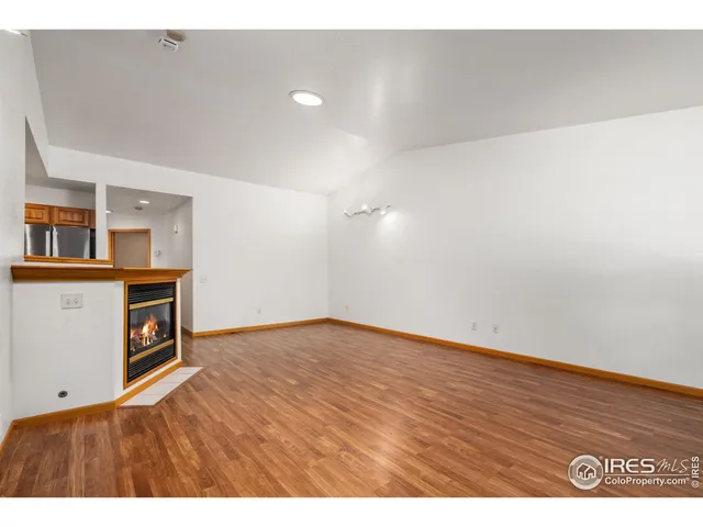 a view of an empty room with workspace and a window