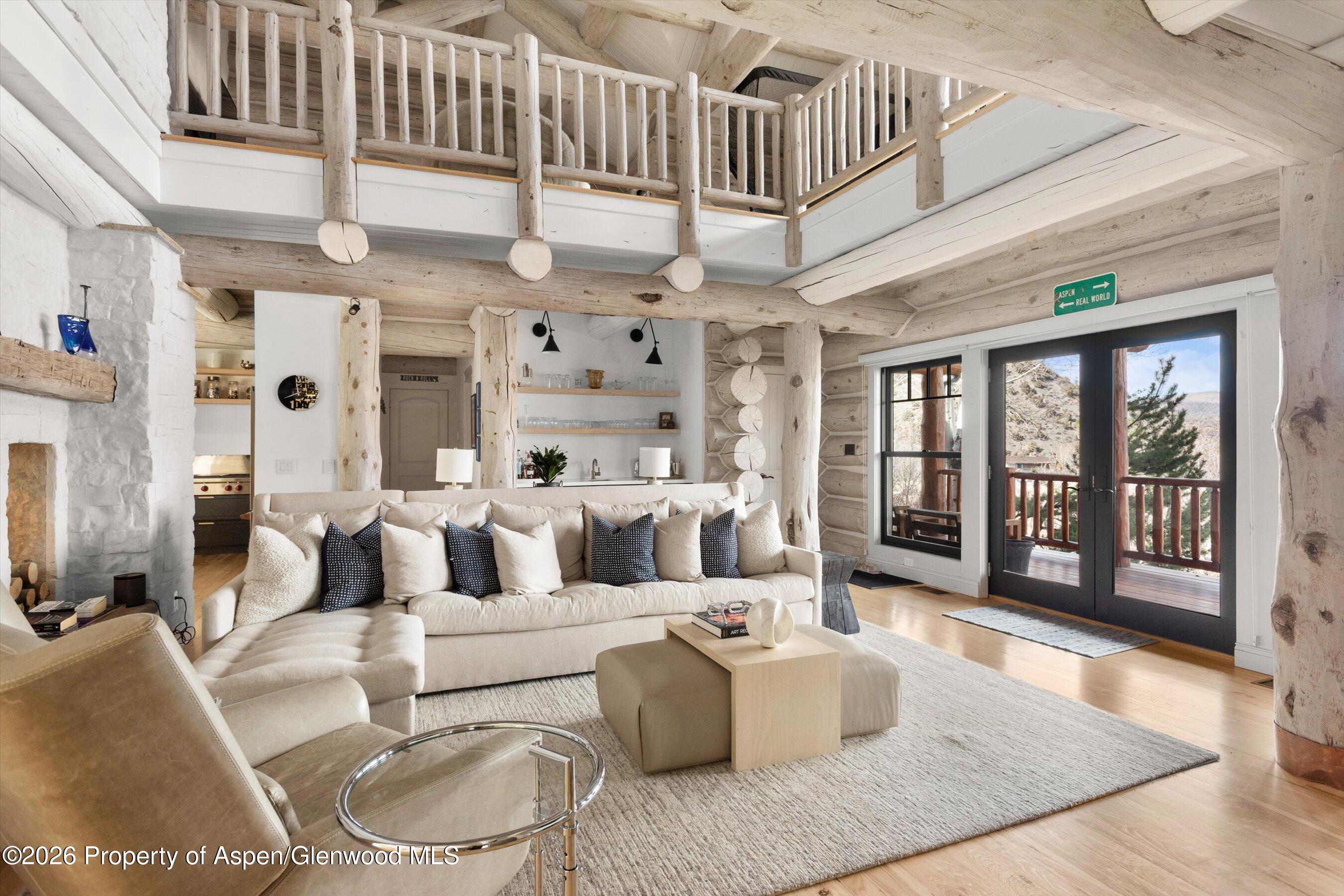 a living room with furniture wooden floor and window