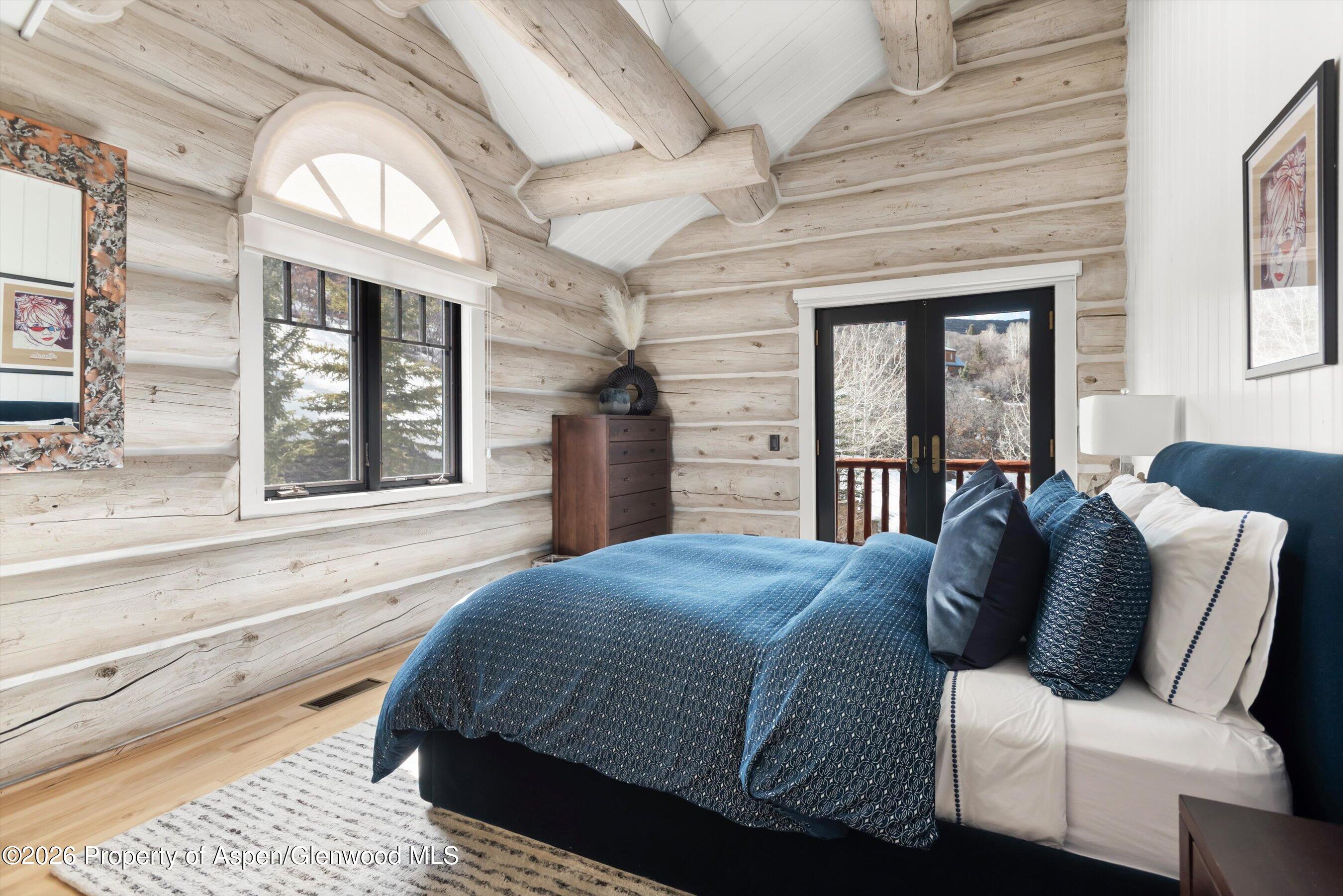 1258 Juniper Hill Road Aspen, CO 81611 - Photo 18 of 25 a bedroom with a large bed and a large window