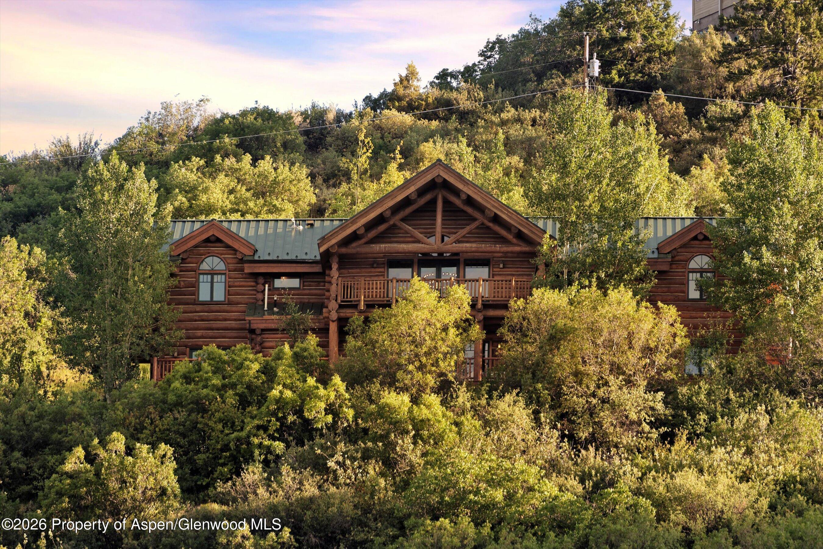 1258 Juniper Hill Road Aspen, CO 81611 - Photo 2 of 25 a front view of a house with a yard