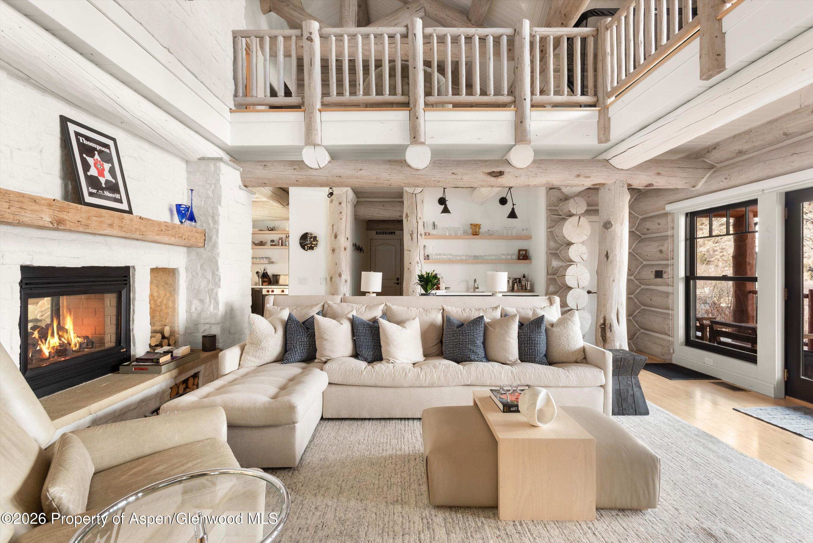 1258 Juniper Hill Road Aspen, CO 81611 - Photo 4 of 25 a living room with furniture a fireplace and a large window