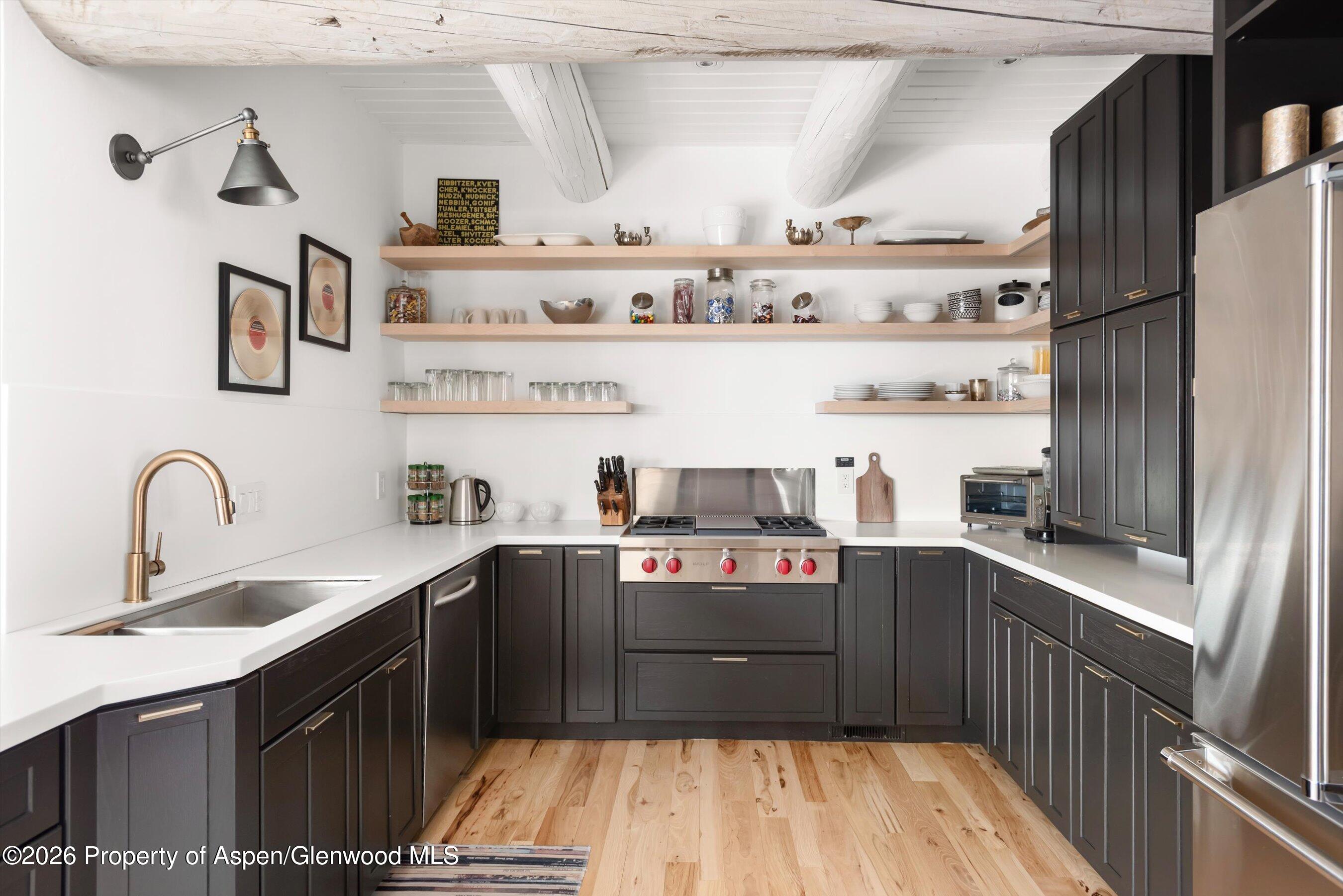 1258 Juniper Hill Road Aspen, CO 81611 - Photo 7 of 25 a kitchen with kitchen island granite countertop a sink stainless steel appliances and cabinets