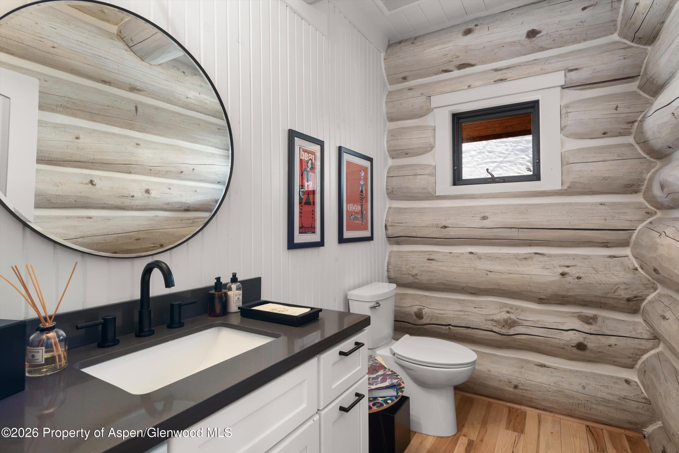 1258 Juniper Hill Road Aspen, CO 81611 - Photo 8 of 25 a bathroom with a toilet a sink and mirror