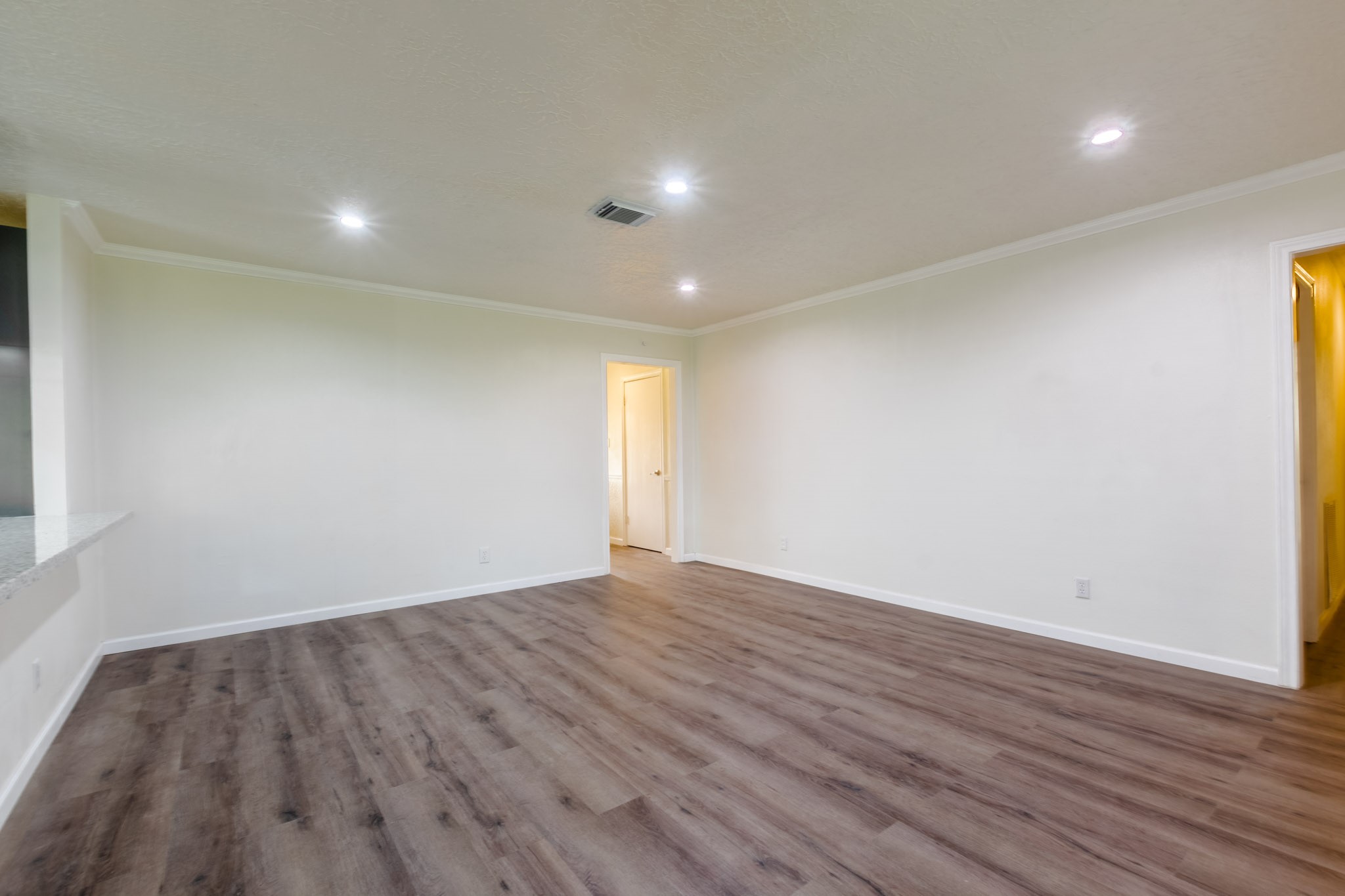 9646 Springview Lane Houston, TX 77080 - Photo 11 of 32 an empty room with wooden floor and windows