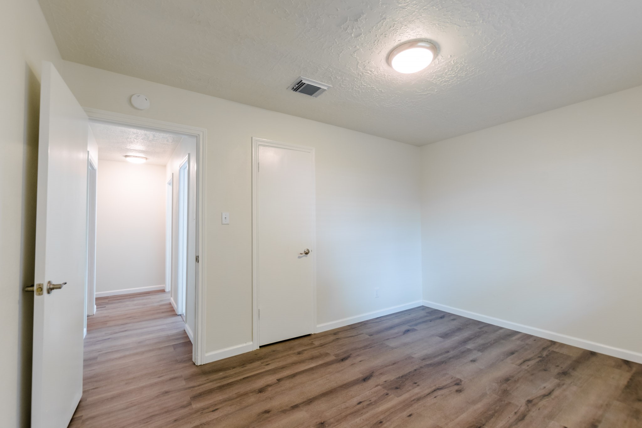 9646 Springview Lane Houston, TX 77080 - Photo 19 of 32 a view of an empty room with wooden floor