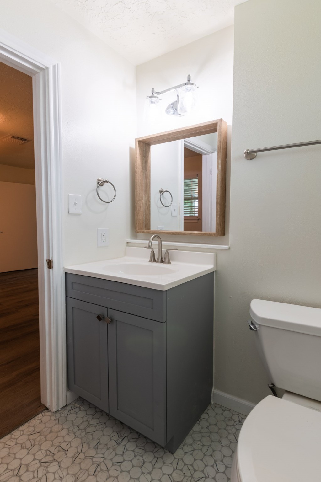 9646 Springview Lane Houston, TX 77080 - Photo 24 of 32 a bathroom with a toilet sink and mirror