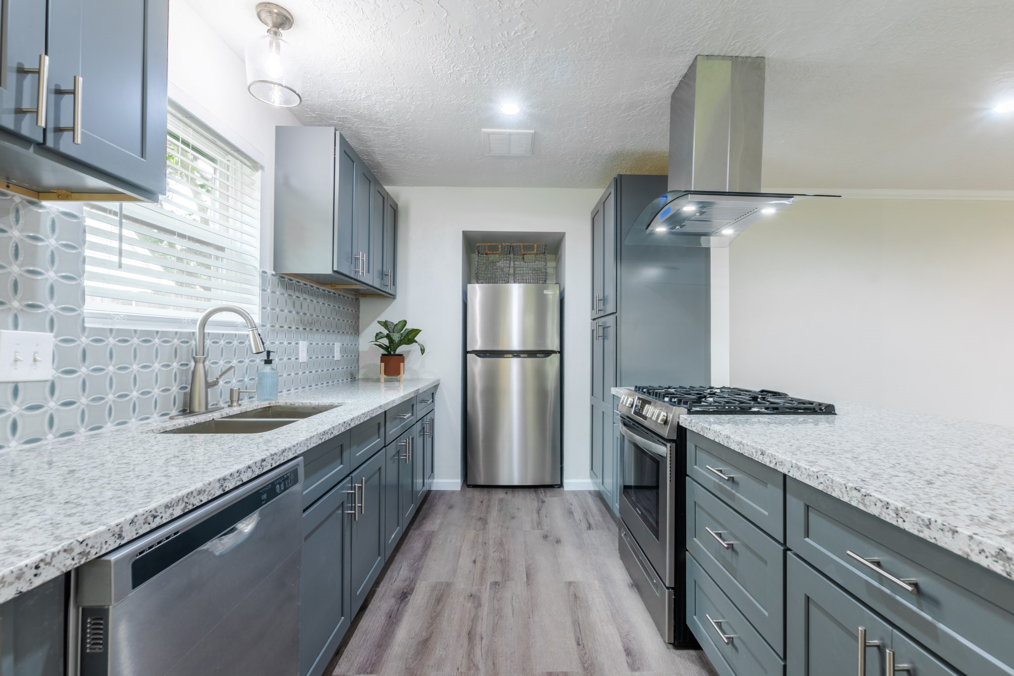 9646 Springview Lane Houston, TX 77080 - Photo 8 of 32 a kitchen with stainless steel appliances granite countertop a sink stove and refrigerator