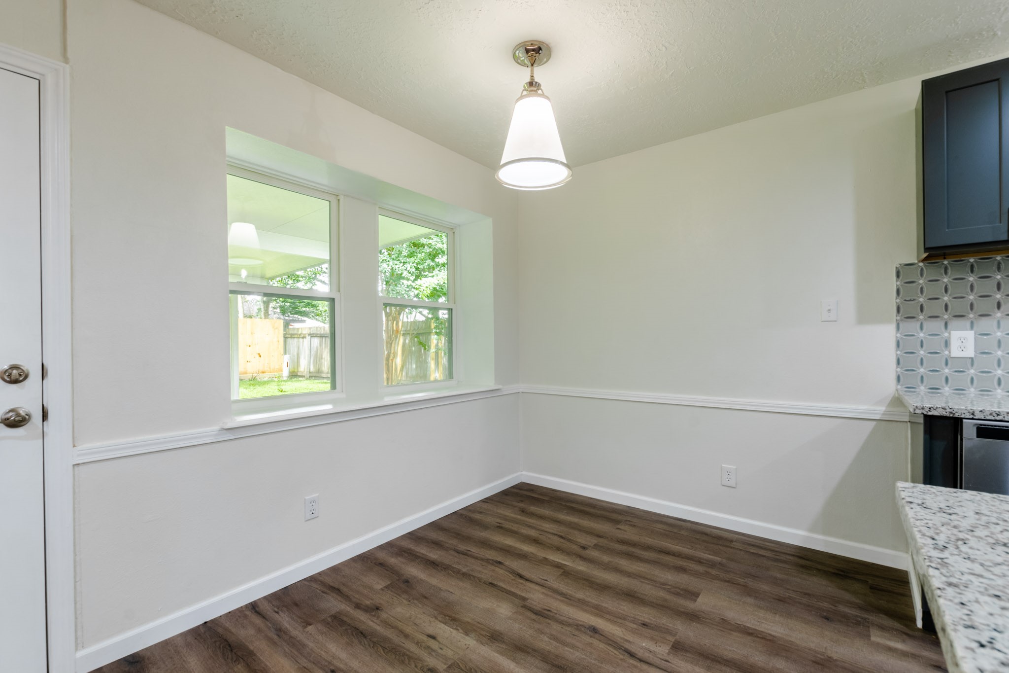 9646 Springview Lane Houston, TX 77080 - Photo 10 of 32 a view of an empty room with wooden floor and a window