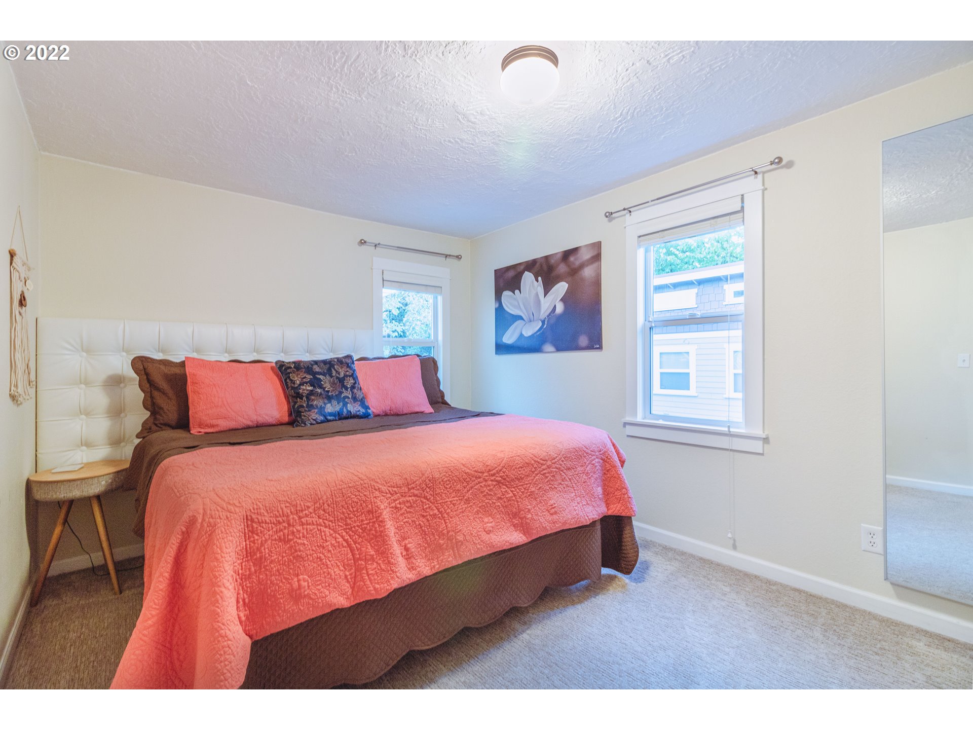 11910 Southwest Denney Road Beaverton, OR 97008 - Photo 13 of 22 a bedroom with a bed and wooden floor