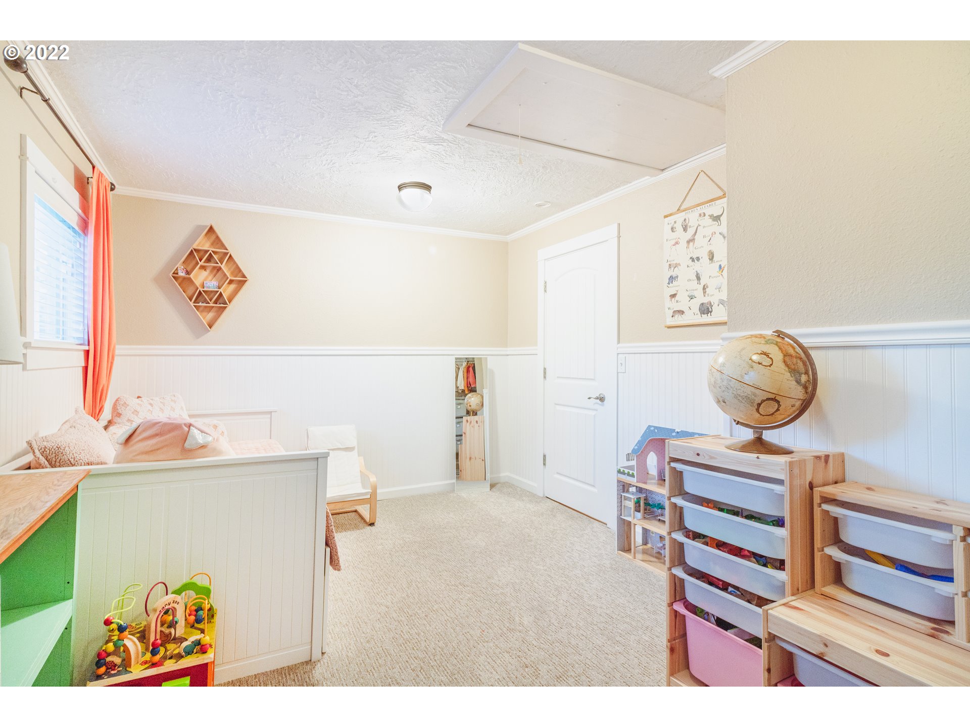 11910 Southwest Denney Road Beaverton, OR 97008 - Photo 16 of 22 a bedroom with a baby bed a desk and chair with the wooden floor