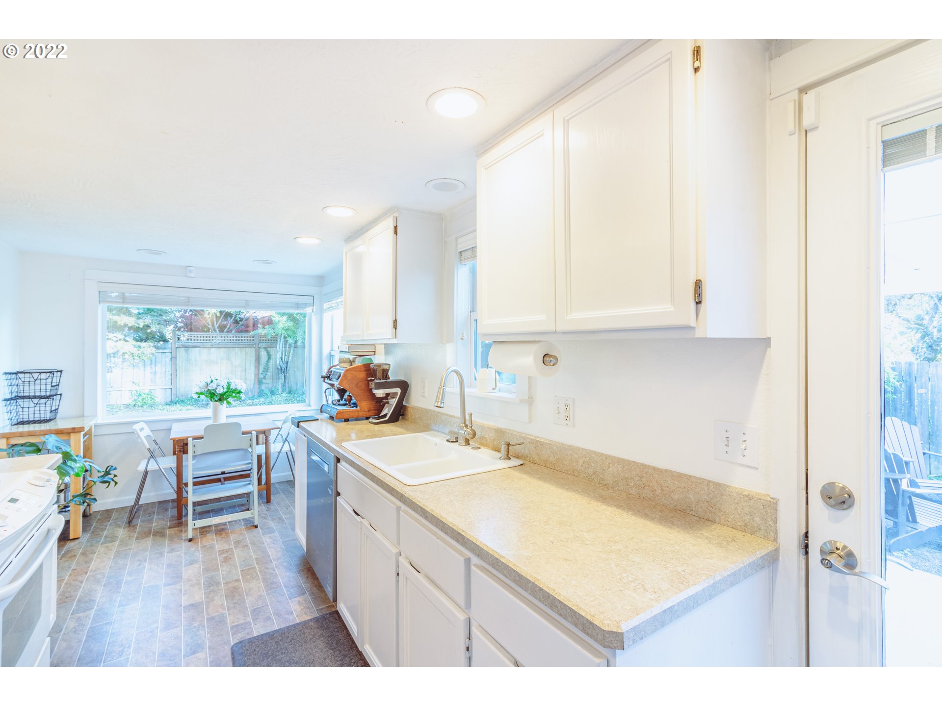 11910 Southwest Denney Road Beaverton, OR 97008 - Photo 6 of 22 a kitchen with a sink cabinets and wooden floor