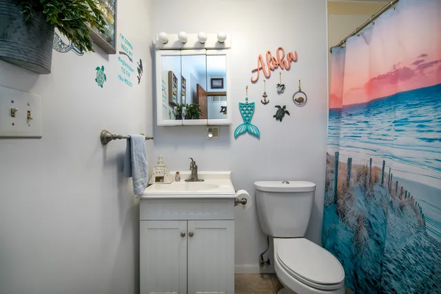 a bathroom with a toilet sink and mirror