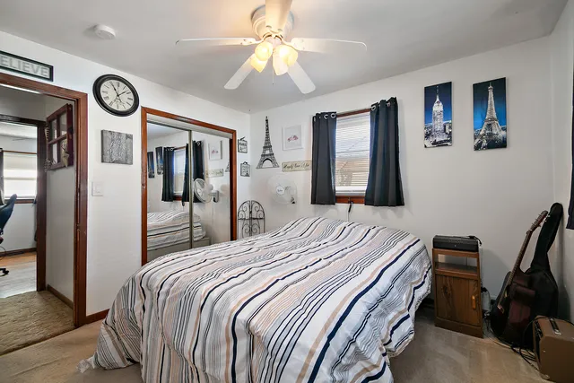 a bedroom with a bed and a clock on the wall