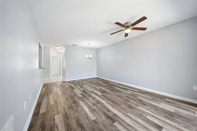 a view of empty room with ceiling fan