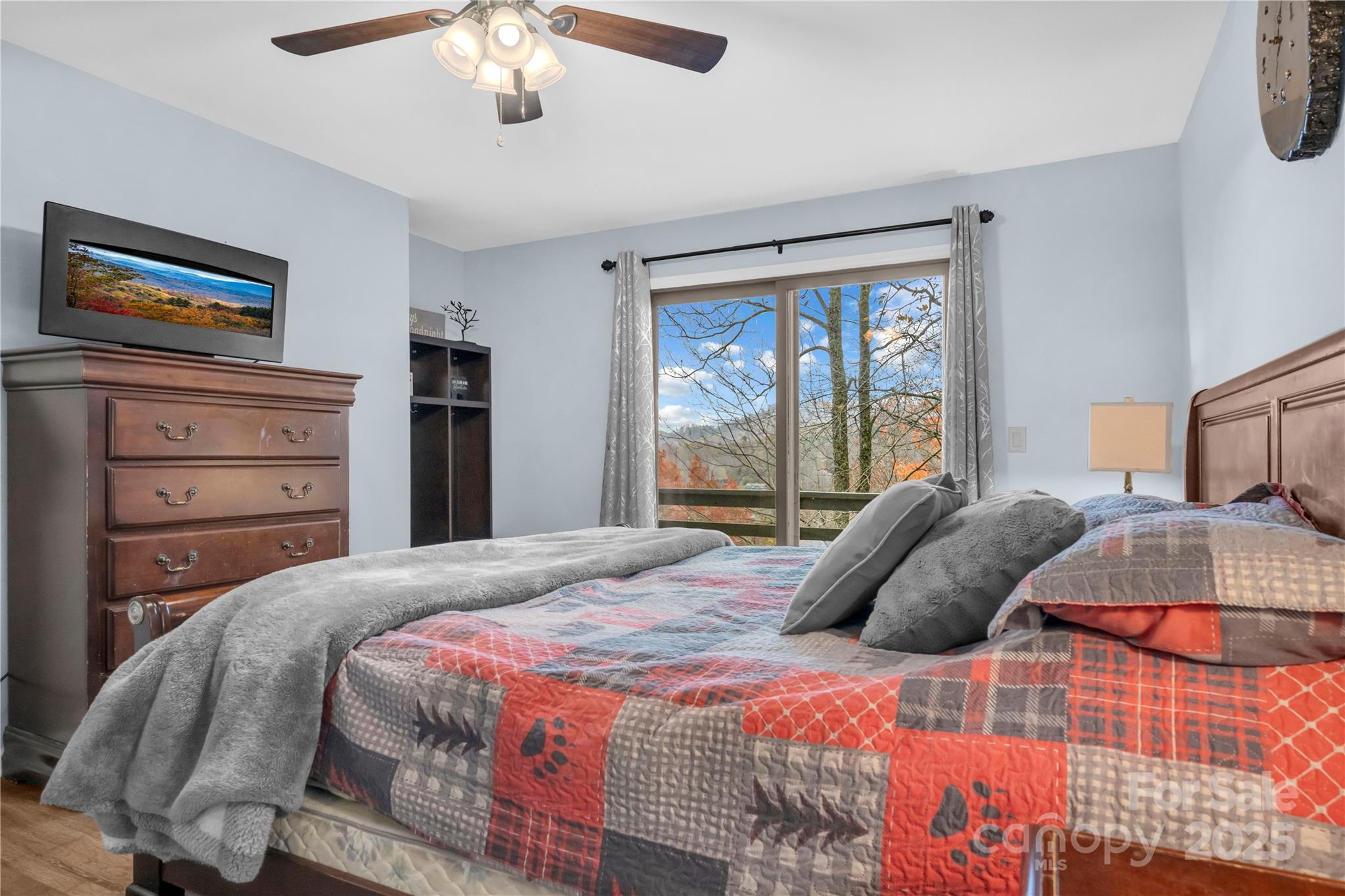 555 Glenview Road Newland, NC 28657 - Photo 13 of 48 a bedroom with a large bed and a chandelier