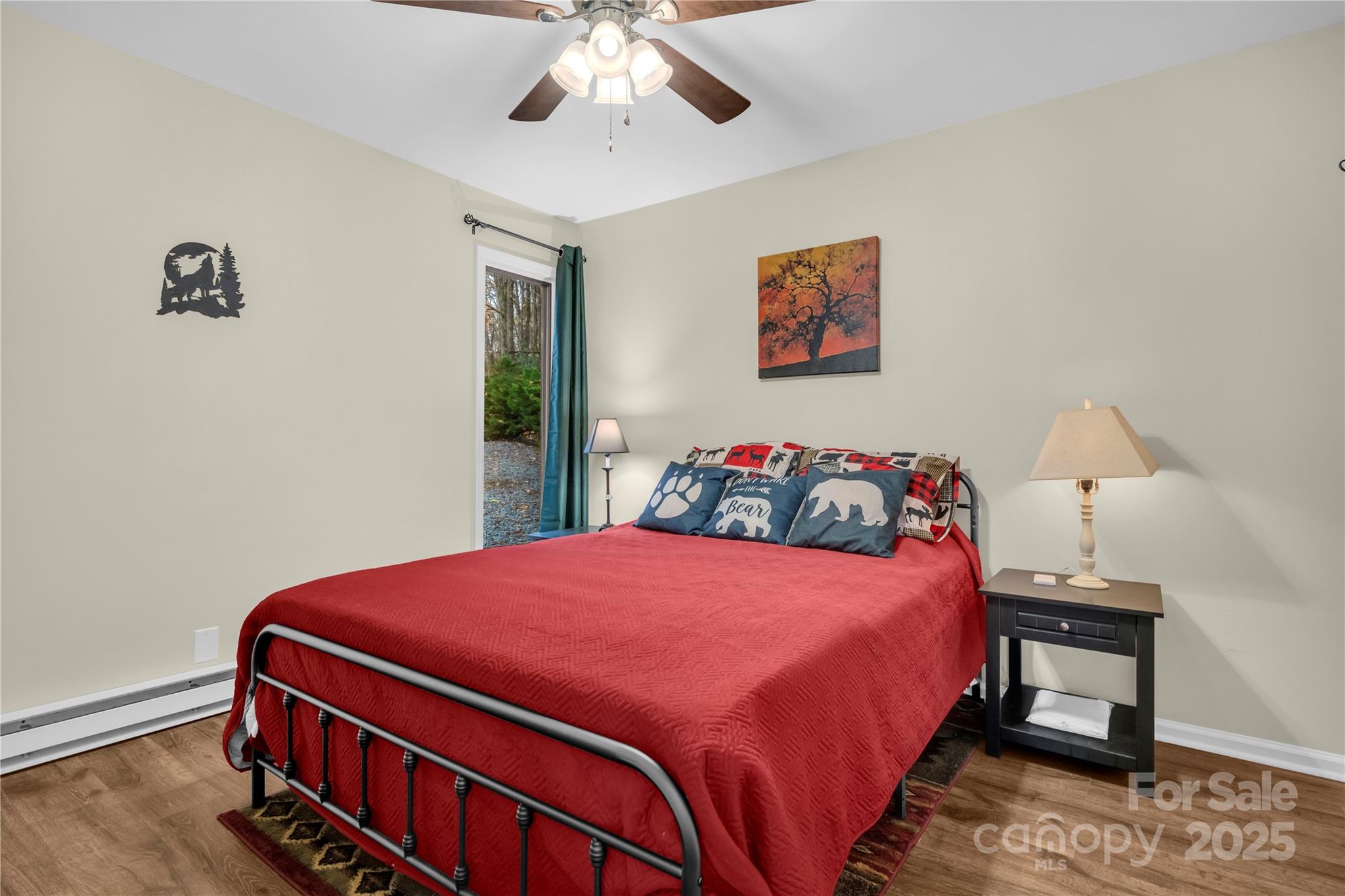 555 Glenview Road Newland, NC 28657 - Photo 19 of 48 a bedroom with a bed and a chandelier