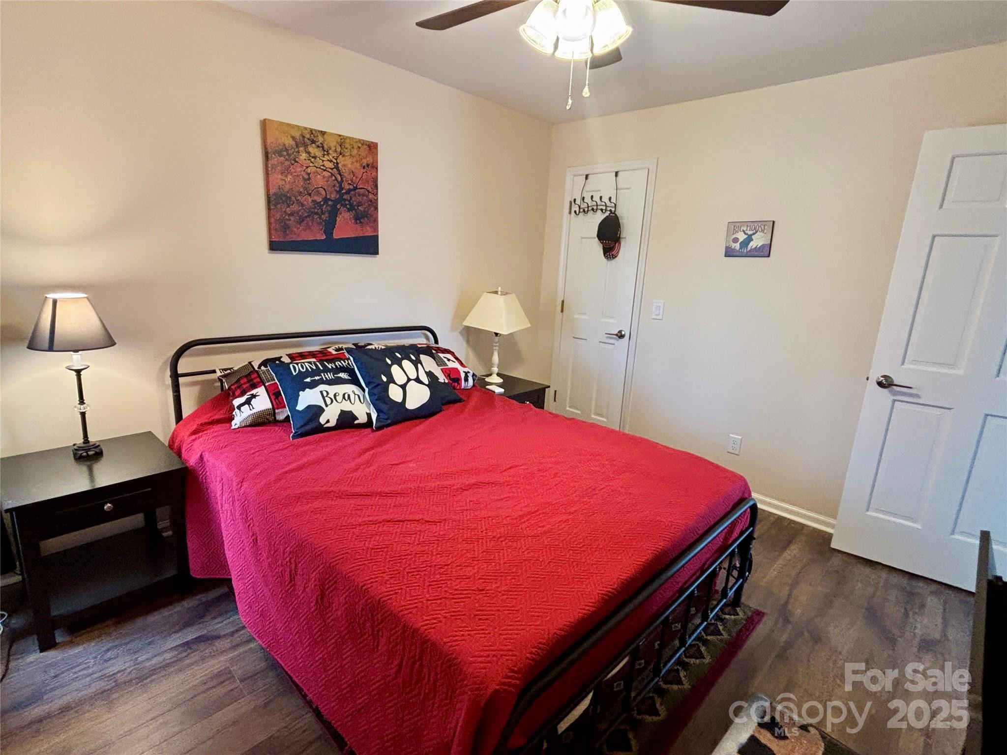 555 Glenview Road Newland, NC 28657 - Photo 20 of 48 a bedroom with a bed and a chandelier