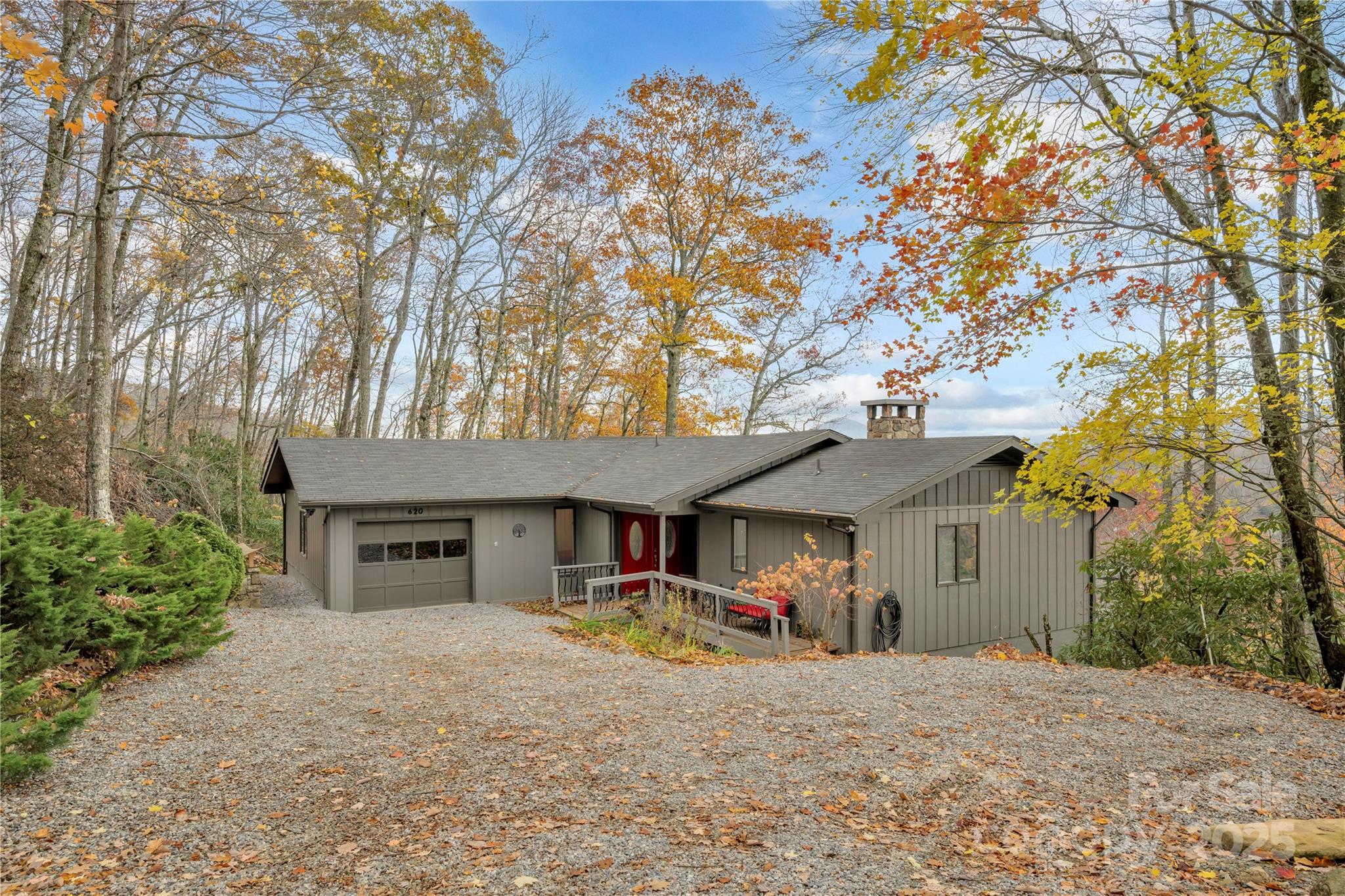 555 Glenview Road Newland, NC 28657 - Photo 2 of 48 front view of a house with table and chairs under an large trees