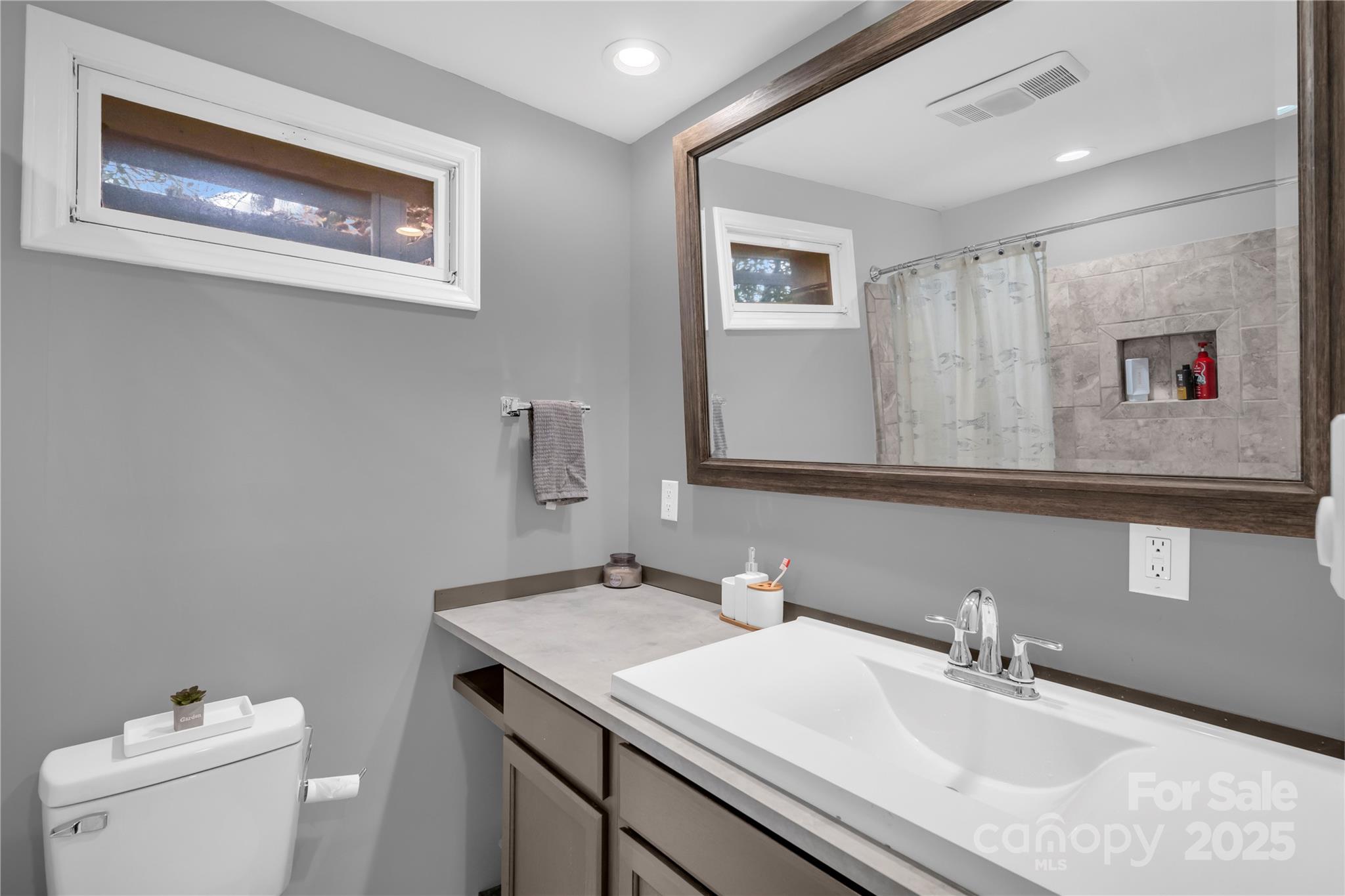555 Glenview Road Newland, NC 28657 - Photo 29 of 48 a bathroom with a granite countertop sink and a mirror