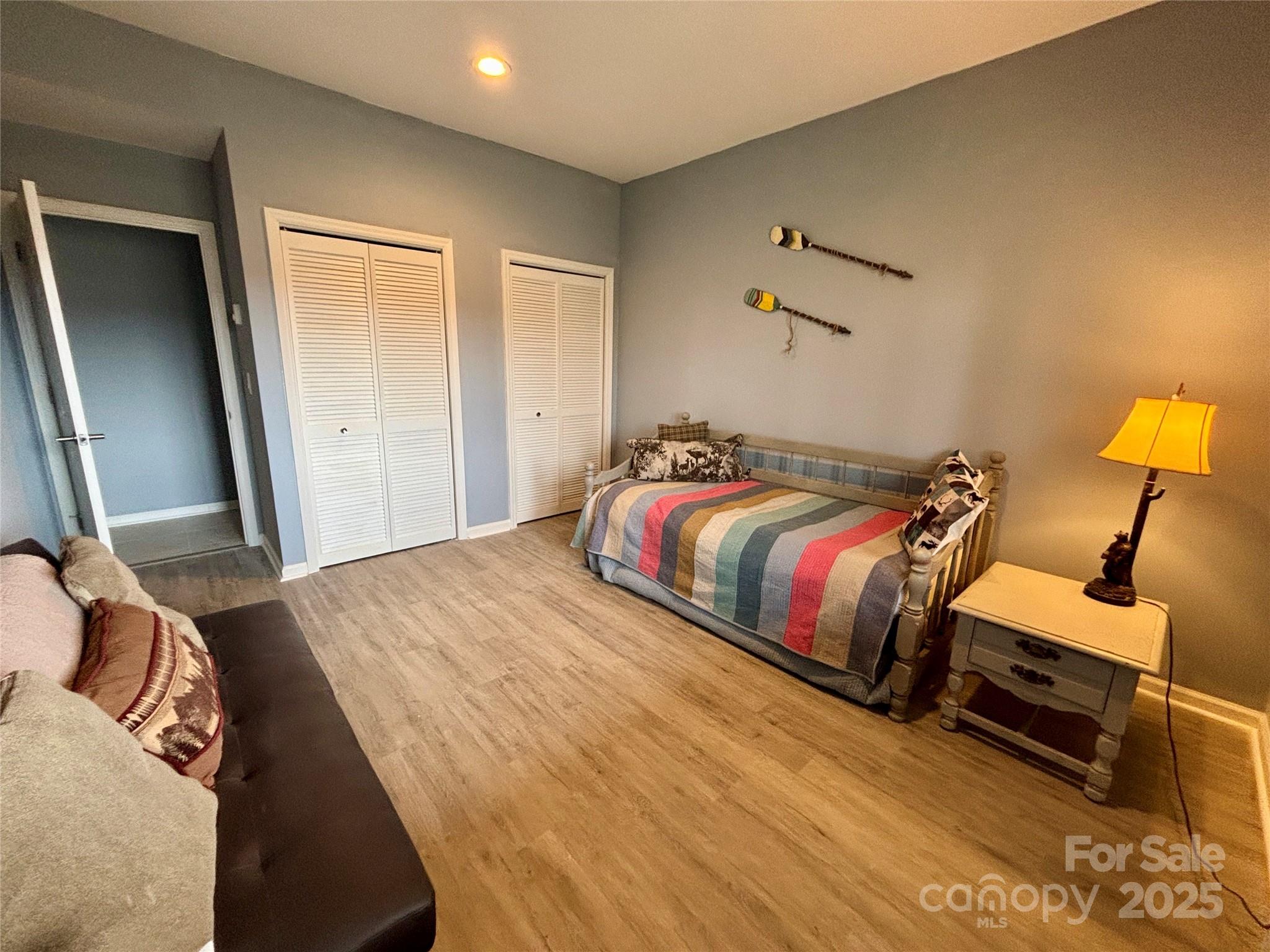 555 Glenview Road Newland, NC 28657 - Photo 32 of 48 a bedroom with a bed and wooden floor