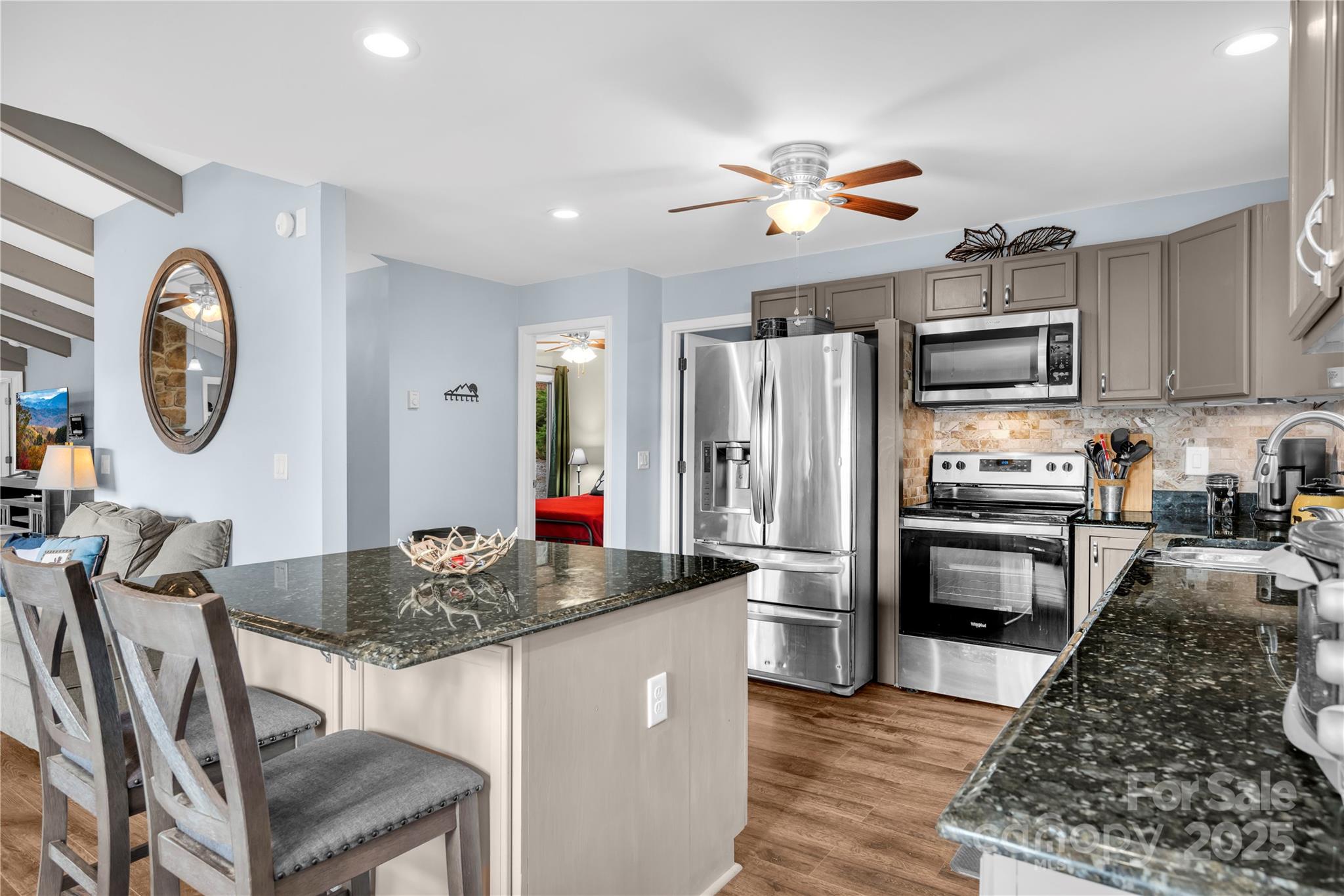 555 Glenview Road Newland, NC 28657 - Photo 10 of 48 a kitchen with granite countertop a stove a refrigerator and a dining table