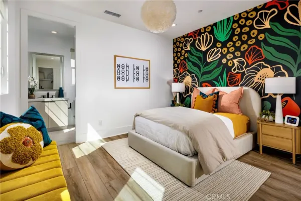 a bedroom with a bed and a painting on the wall