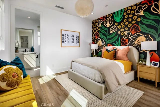 a bedroom with a bed and a painting on the wall