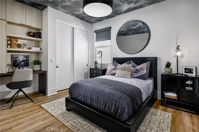 a bedroom with a bed and a potted plant