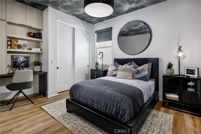 a bedroom with bed and a mirror