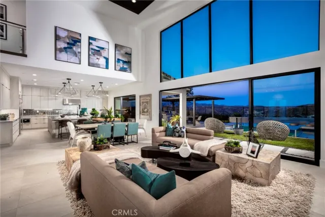 a living room with furniture and view of kitchen