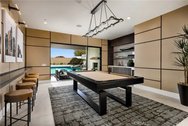 a room with pool table and windows