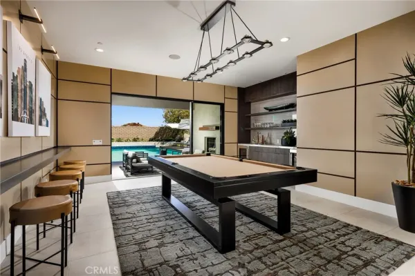 a room with pool table and windows