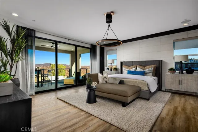 a spacious bedroom with a bed couch and a large window