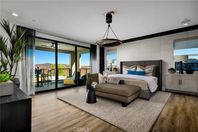 a spacious bedroom with a bed couch and a large window